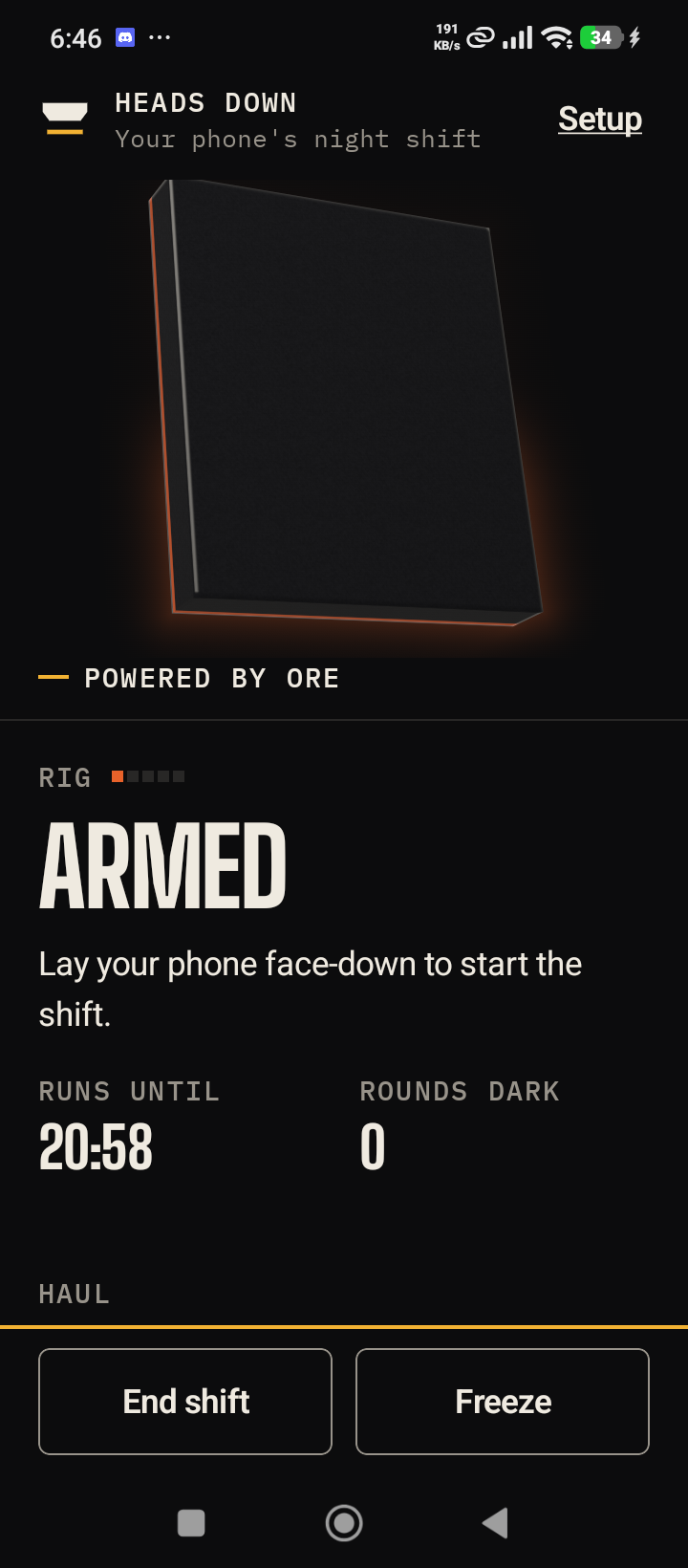 The home screen on the Redmi 14C with the rig armed: ember light under the slab, the word Armed, and Lay your phone face-down to start the shift